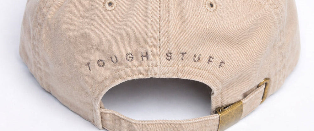 Beige cap with 'Tough Stuff' text on a white background